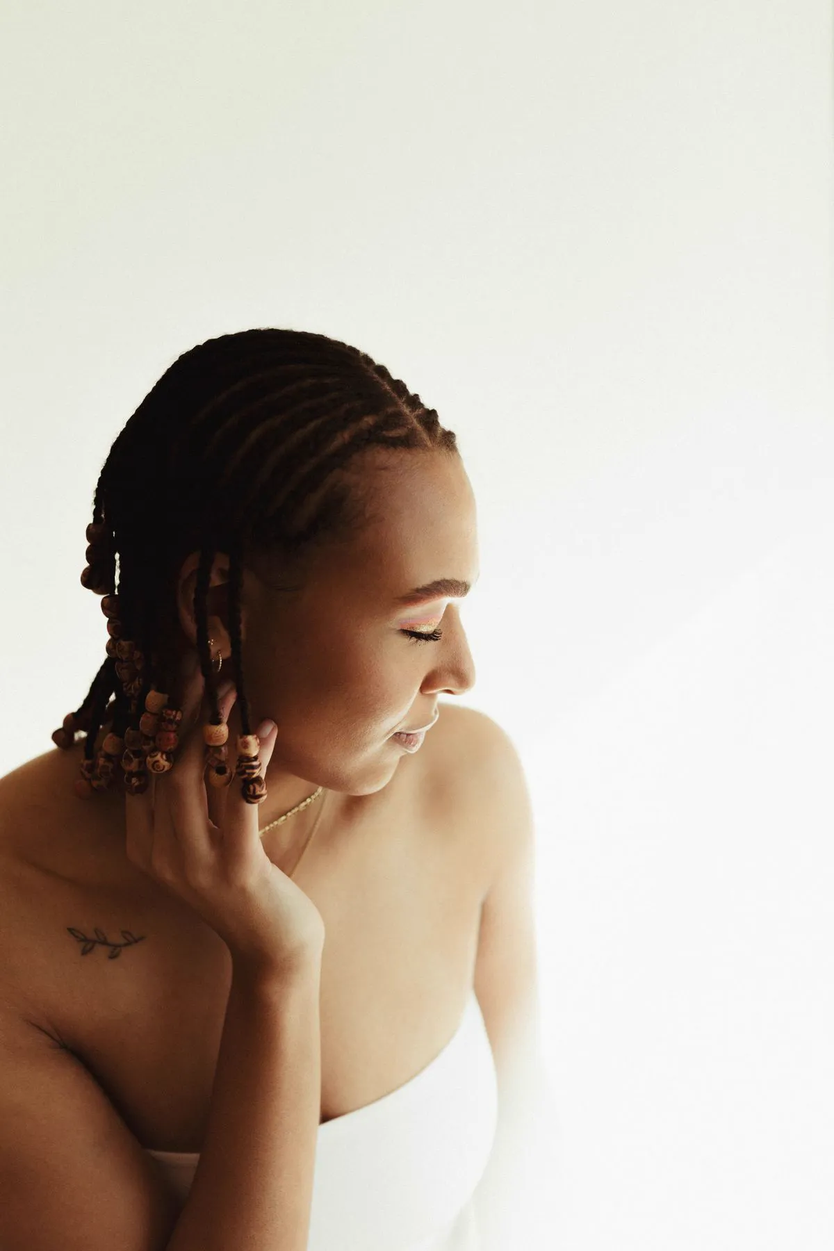 Cornrows with wooden beads, side profile portrait