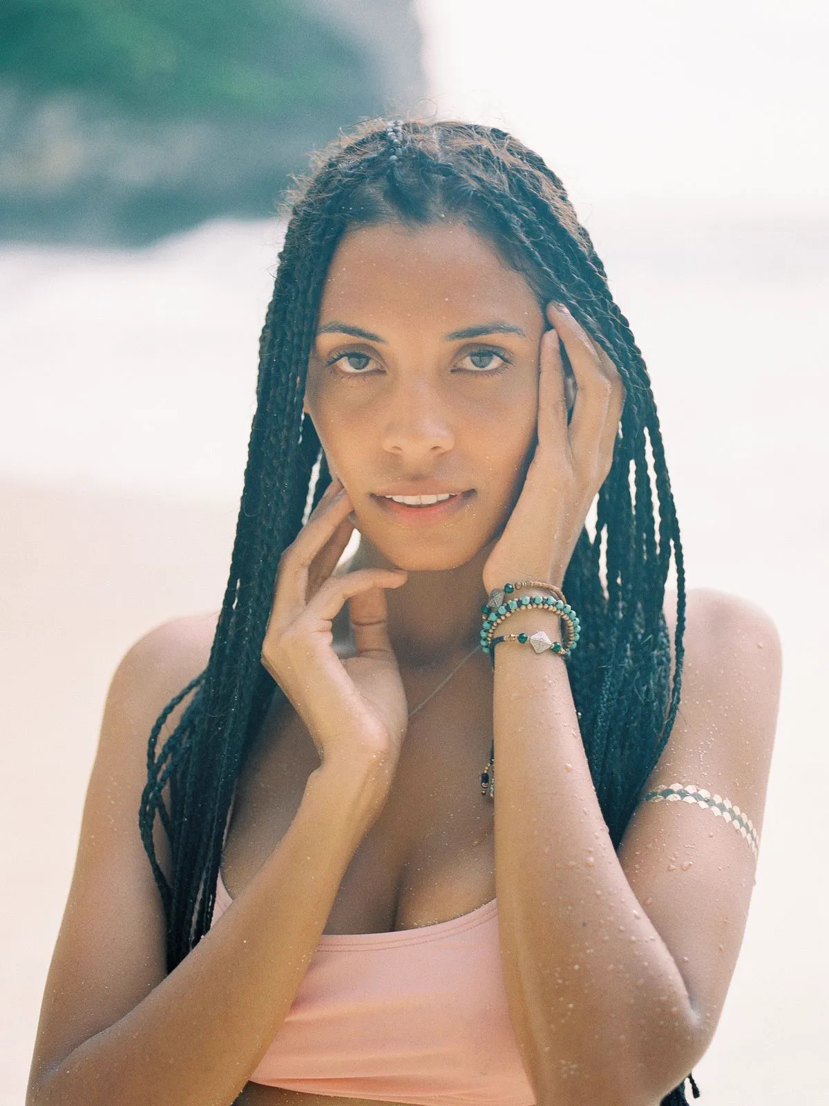 Portrait of a woman with box braids on the beach
